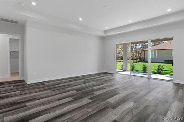 unfurnished living room featuring dark wood-style floors, recessed lighting, visible vents, and baseboards