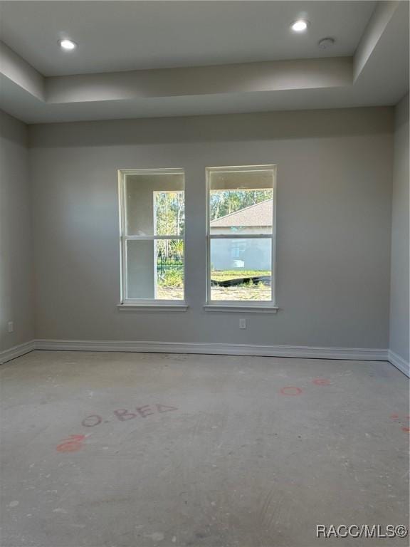 empty room featuring a tray ceiling