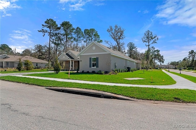 view of front of property featuring a front lawn and stucco siding