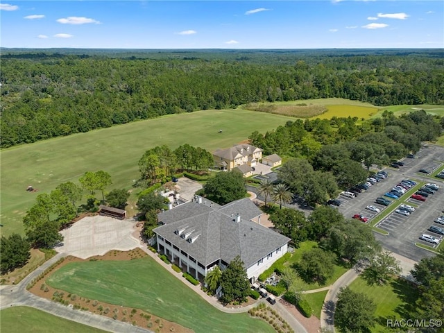 drone / aerial view with a wooded view