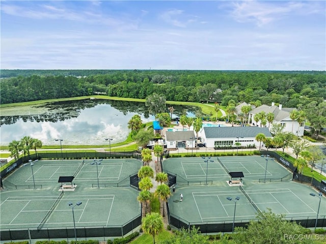 bird's eye view with a water view and a wooded view