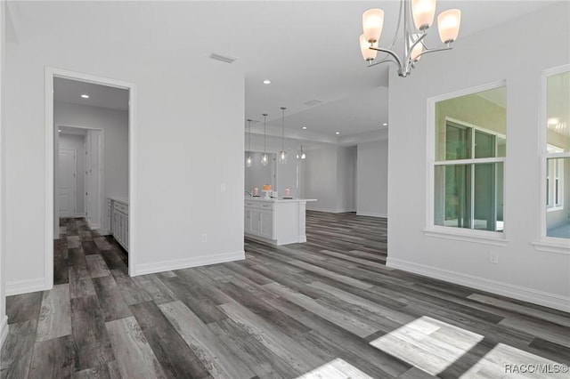 unfurnished living room featuring baseboards, wood finished floors, visible vents, and recessed lighting