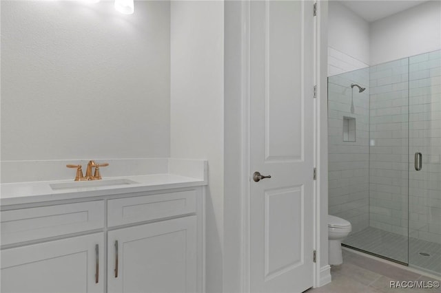 full bathroom featuring toilet, a stall shower, tile patterned flooring, and vanity