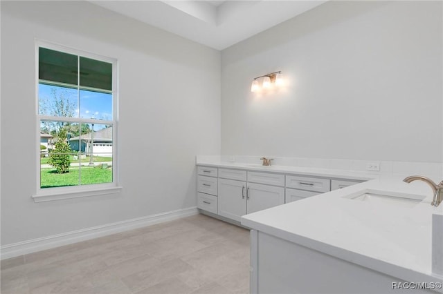 bathroom featuring vanity and baseboards