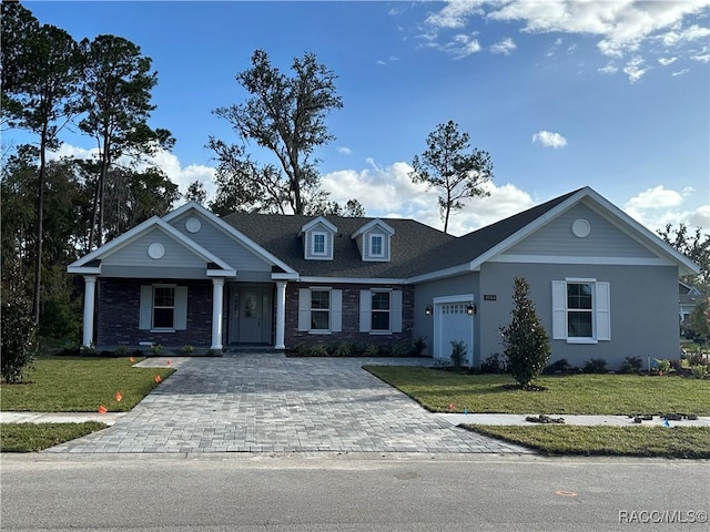 view of front of property featuring a garage and a front yard