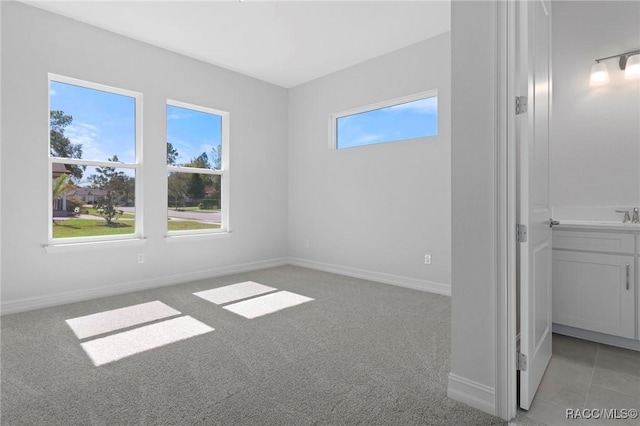 unfurnished bedroom with light carpet and baseboards