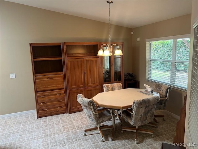 carpeted dining area featuring a notable chandelier and lofted ceiling