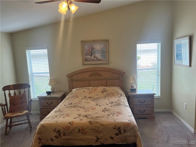 bedroom with ceiling fan, vaulted ceiling, and multiple windows