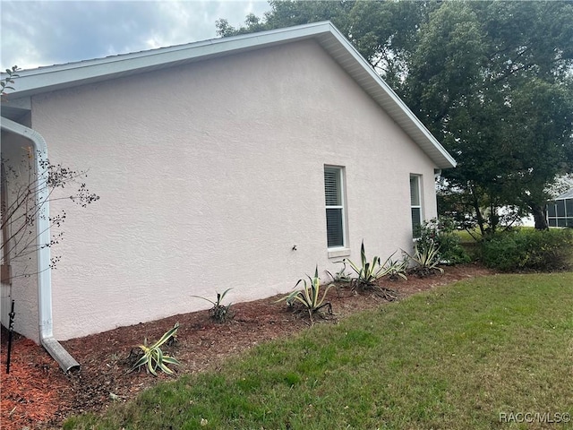 view of property exterior featuring a yard