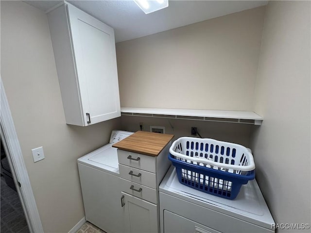 laundry area featuring cabinets and washer / dryer