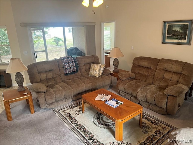 carpeted living room with ceiling fan