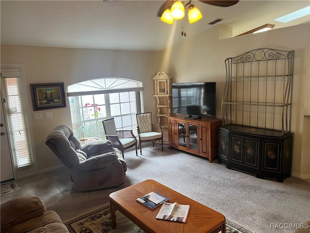 living room with ceiling fan and carpet