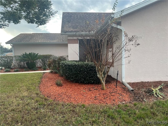 view of property exterior with a lawn