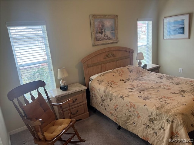 bedroom featuring dark colored carpet