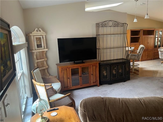 living room with a healthy amount of sunlight, lofted ceiling, and carpet floors