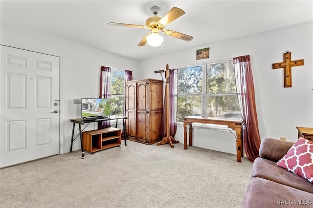 interior space featuring ceiling fan and light carpet