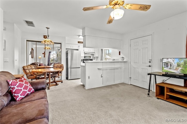 carpeted living room with ceiling fan