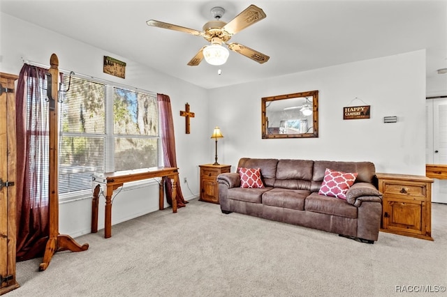 carpeted living room featuring ceiling fan