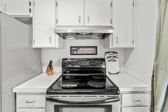 kitchen featuring ventilation hood, white fridge, white cabinets, and black range with electric cooktop