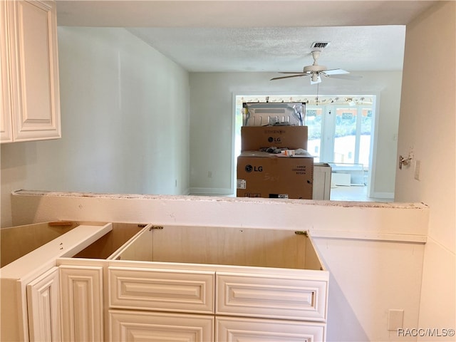 kitchen featuring ceiling fan and a textured ceiling