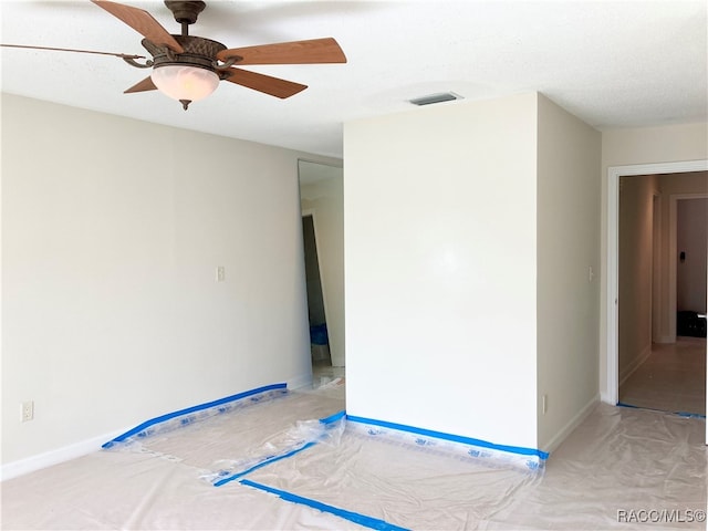 empty room featuring ceiling fan and a textured ceiling