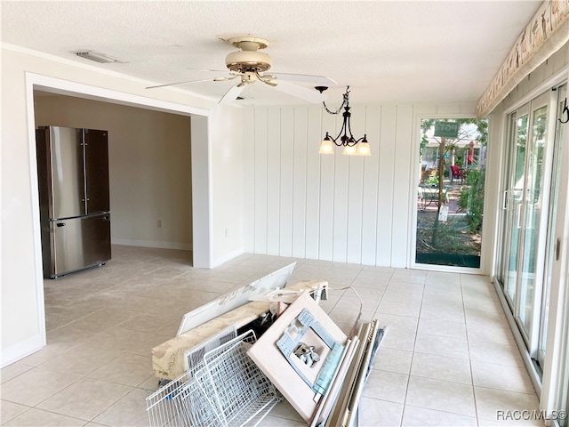 interior space with ceiling fan with notable chandelier