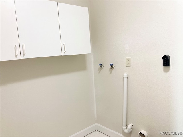 clothes washing area with gas dryer hookup, cabinets, and washer hookup