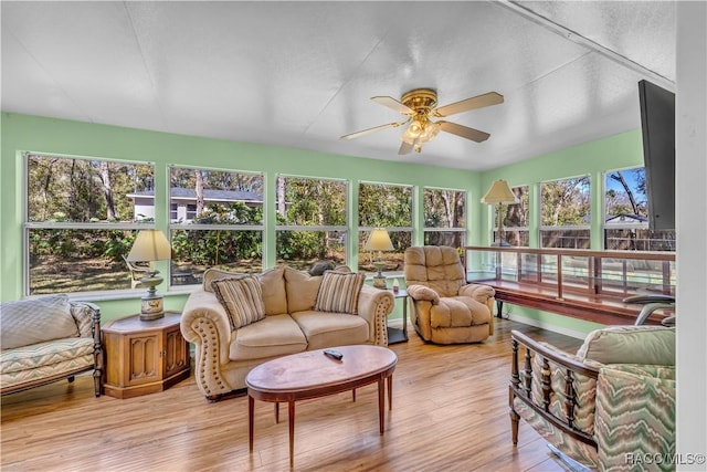 sunroom / solarium featuring a ceiling fan