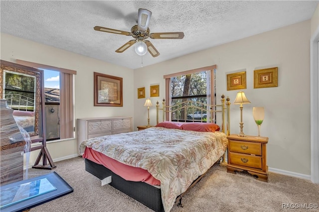 bedroom with carpet flooring, a textured ceiling, and baseboards