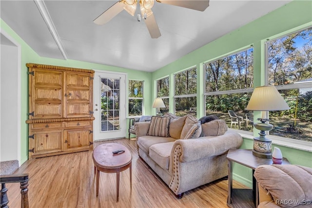 sunroom / solarium with a ceiling fan