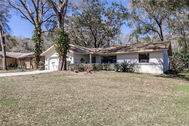 single story home with stucco siding, an attached garage, driveway, and a front yard