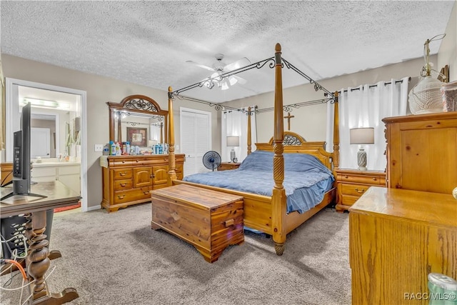 bedroom featuring light carpet, a textured ceiling, ensuite bathroom, and ceiling fan