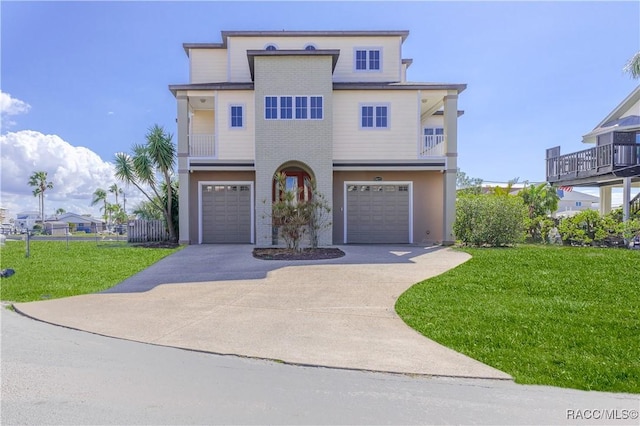 view of front of home with a garage, a balcony, and a front lawn