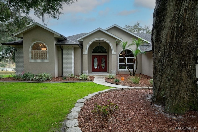 ranch-style house featuring a front lawn