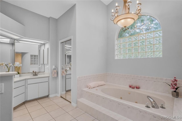 bathroom featuring vanity, tiled bath, tile patterned floors, and a chandelier