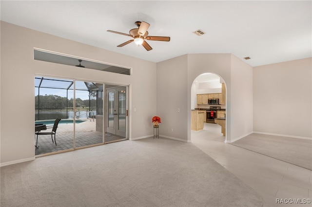 carpeted spare room with ceiling fan