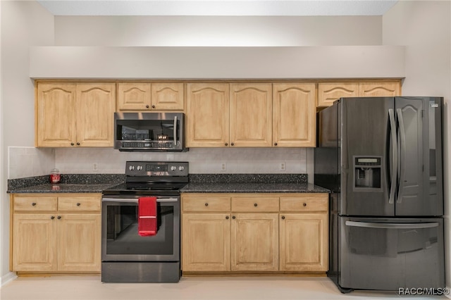 kitchen with tasteful backsplash, dark stone countertops, appliances with stainless steel finishes, and light brown cabinets