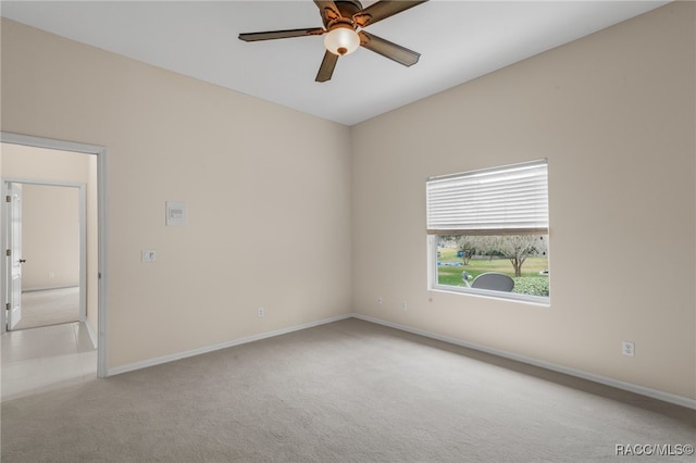 carpeted empty room featuring ceiling fan