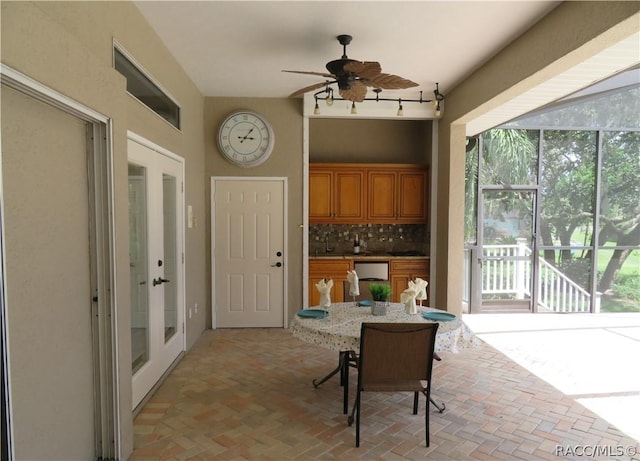 sunroom / solarium featuring ceiling fan