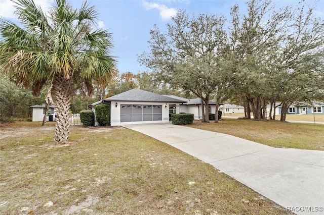 view of front of property with a front yard and a garage