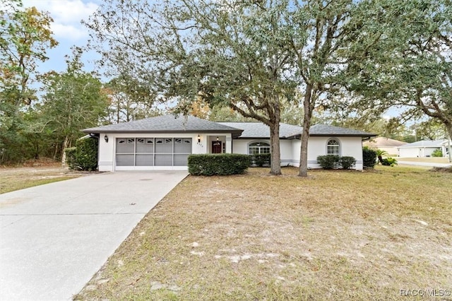 single story home with a garage and a front lawn