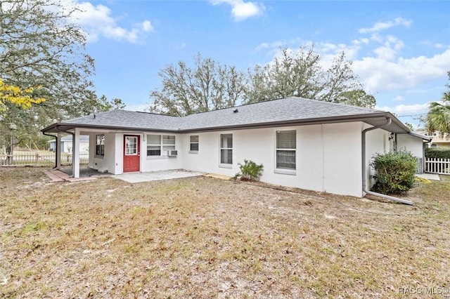 back of property with a yard and a patio area