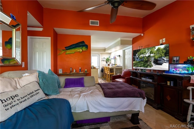 tiled bedroom featuring ceiling fan