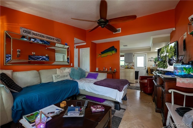 bedroom with a textured ceiling and ceiling fan