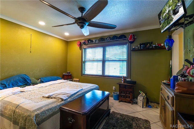 tiled bedroom with ceiling fan, a textured ceiling, and ornamental molding