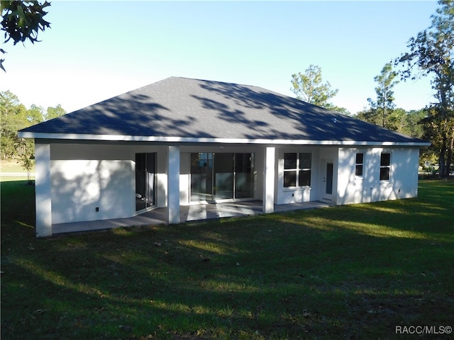 back of house with a yard and a patio