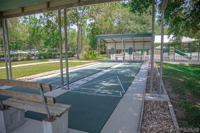 view of property's community featuring a yard and a playground