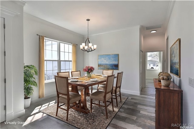 dining space featuring dark hardwood / wood-style floors, an inviting chandelier, a healthy amount of sunlight, and crown molding