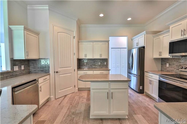 kitchen featuring backsplash, light stone countertops, stainless steel appliances, and light wood-type flooring