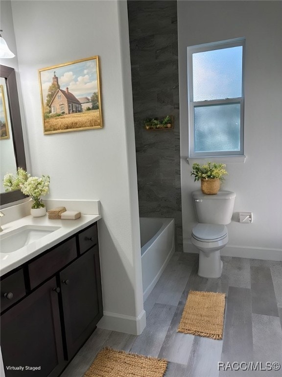 bathroom featuring vanity, hardwood / wood-style flooring, and toilet